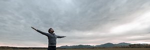 Booking an Appointment. Man with hands outstretched on mountain